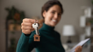 Woman holding keys to house